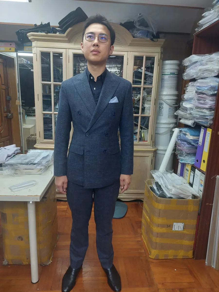Client in a bespoke navy double-breasted suit